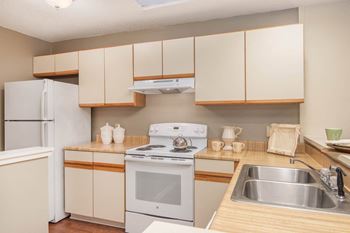 Marsh Cove Apartments in Savannah Georgia photo of a kitchen with white appliances and wooden cabinets